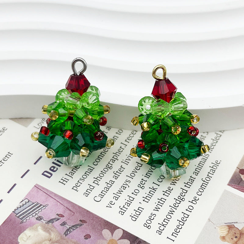 Pair of handmade Christmas tree earrings made from faceted green beads and clear crystal bows