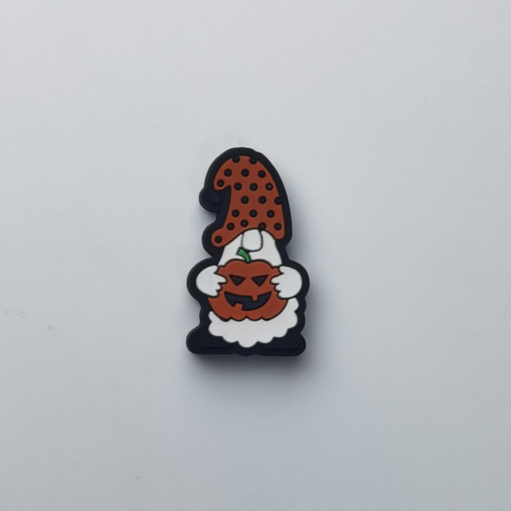 White Halloween gnome silicone focal bead with brown polka-dot hat, holding orange jack-o-lantern pumpkin