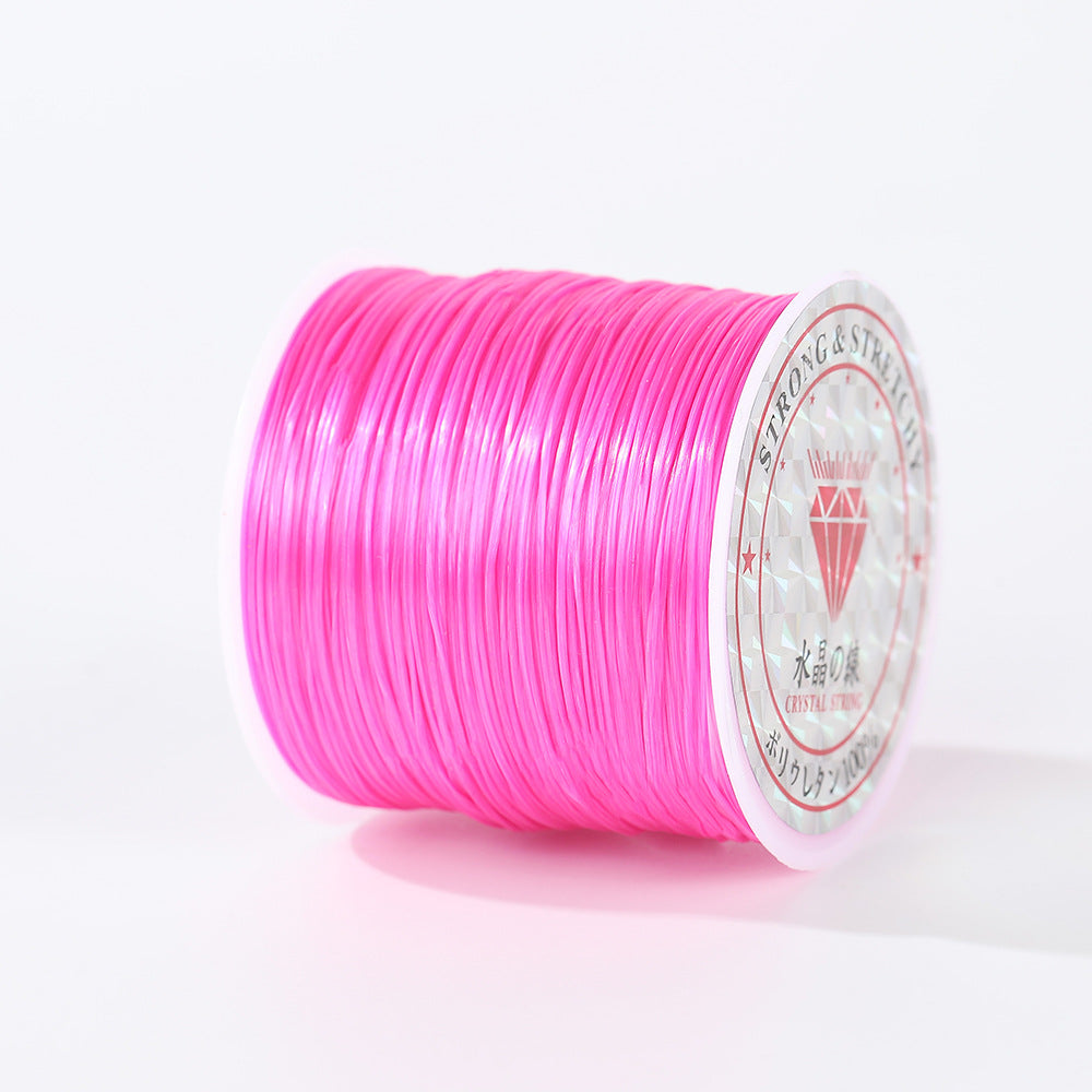 Bright pink 0.8mm flat elastic beading cord spool shown at an angle, diamond logo label visible, white background