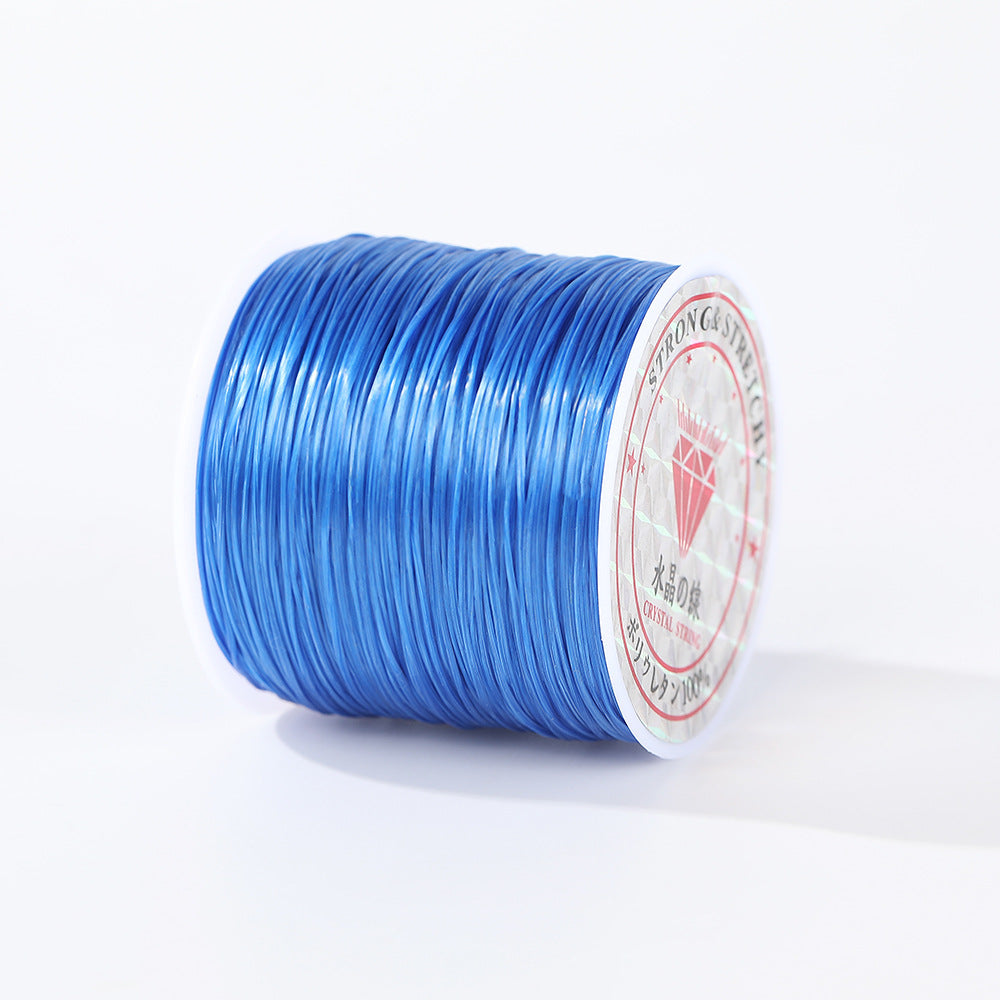 Spool of bright blue 0.8mm flat elastic beading cord on its side, red diamond logo label, white background
