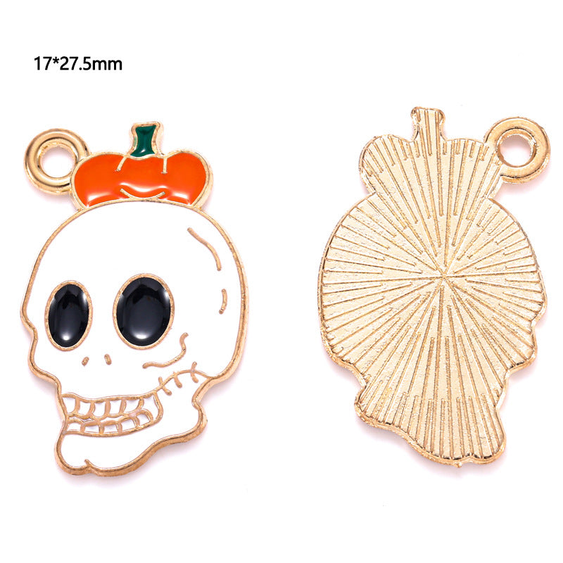 Gold-plated skull and pumpkin charm with black enamel eyes, front and back, 17 by 27.5mm