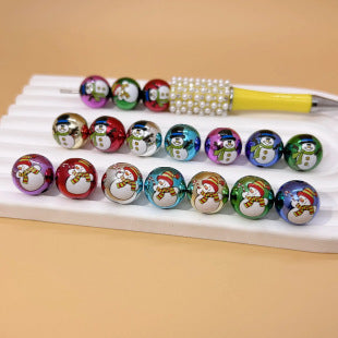 Colorful snowman printed acrylic round beads with rhinestone accents on a white display stand