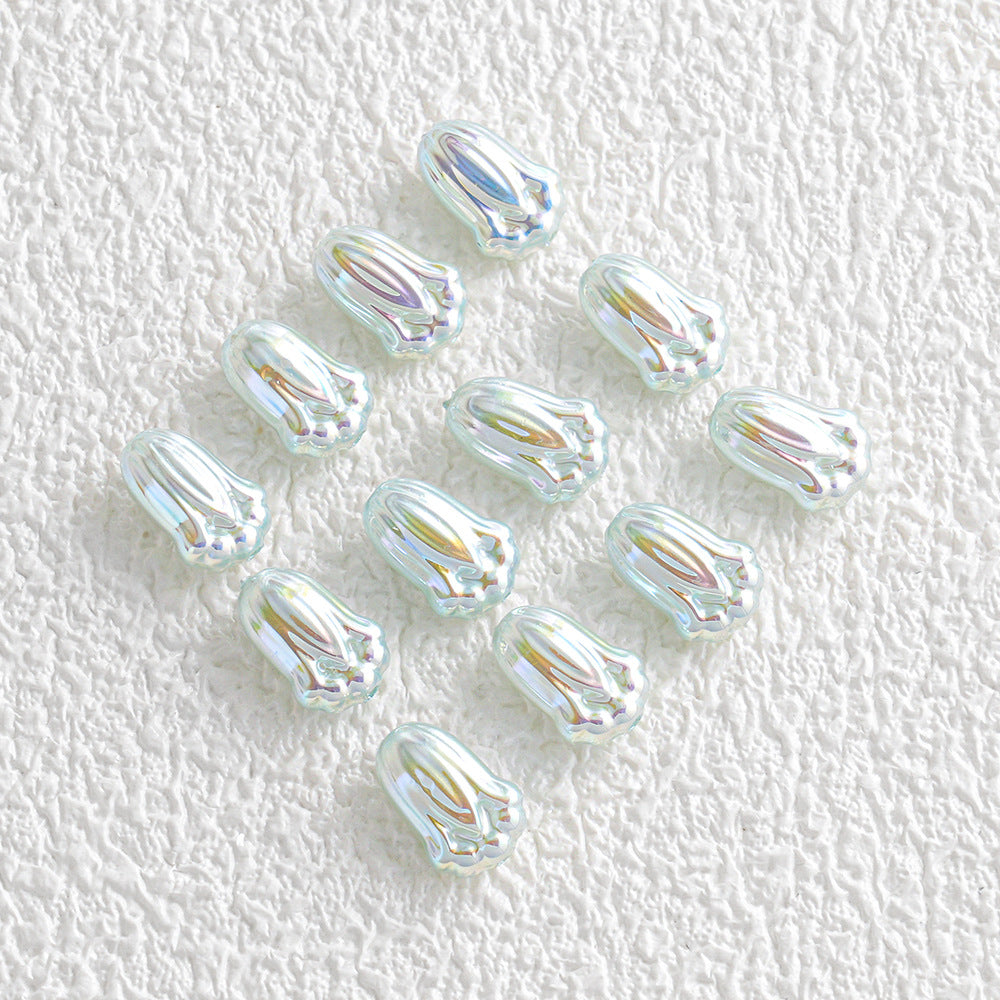 Twelve small iridescent tulip-shaped glass beads in a loose cluster on white