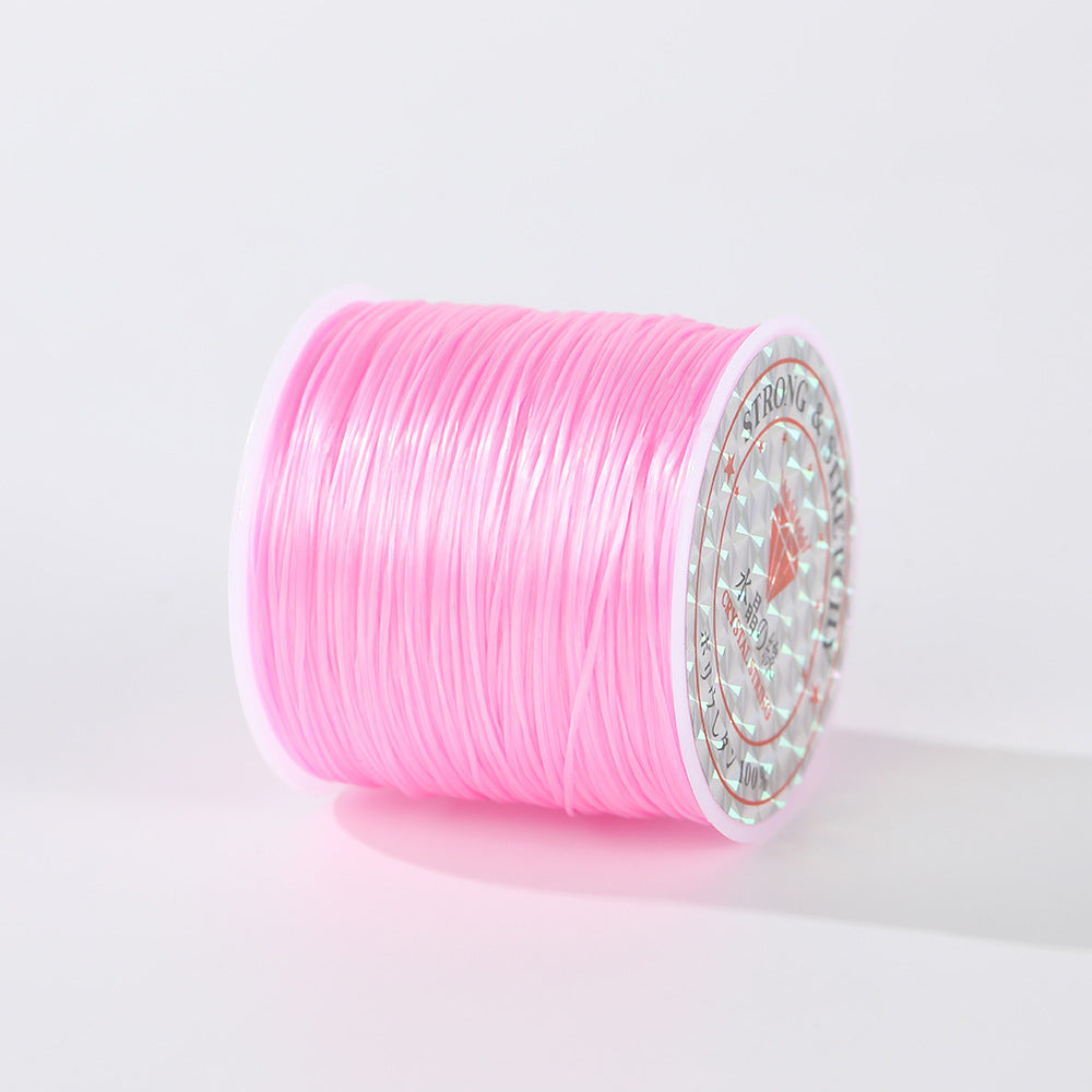 Spool of bright pink 0.8mm flat elastic beading cord lying on its side, holographic label visible, white background