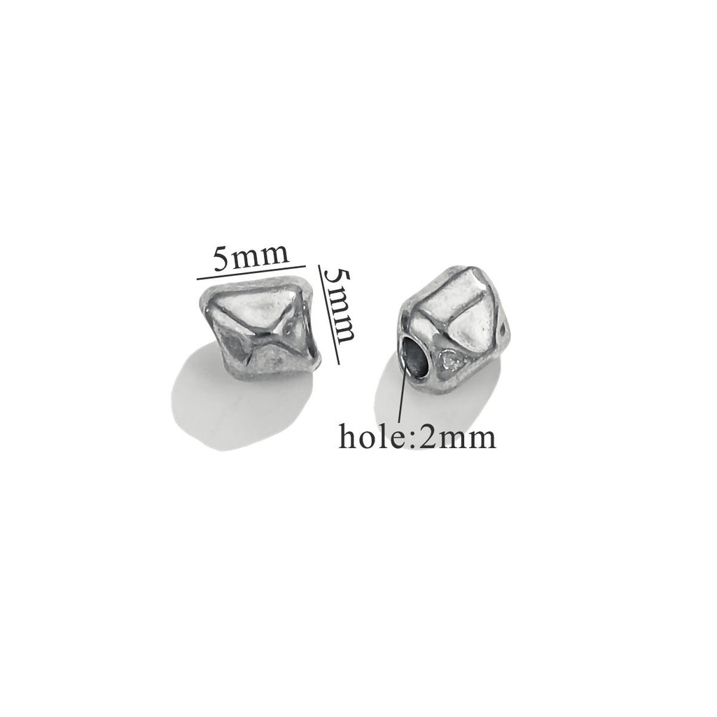 Two small steel-color baroque irregular spacer beads with dimension labels on white background