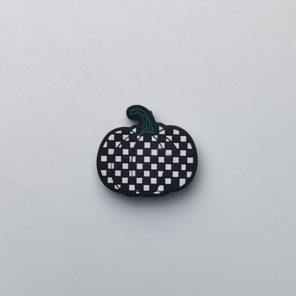 Pumpkin-shaped silicone bead with black and white checkerboard pattern