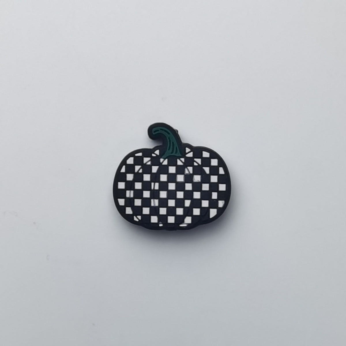 Pumpkin-shaped silicone bead with black and white checkerboard pattern