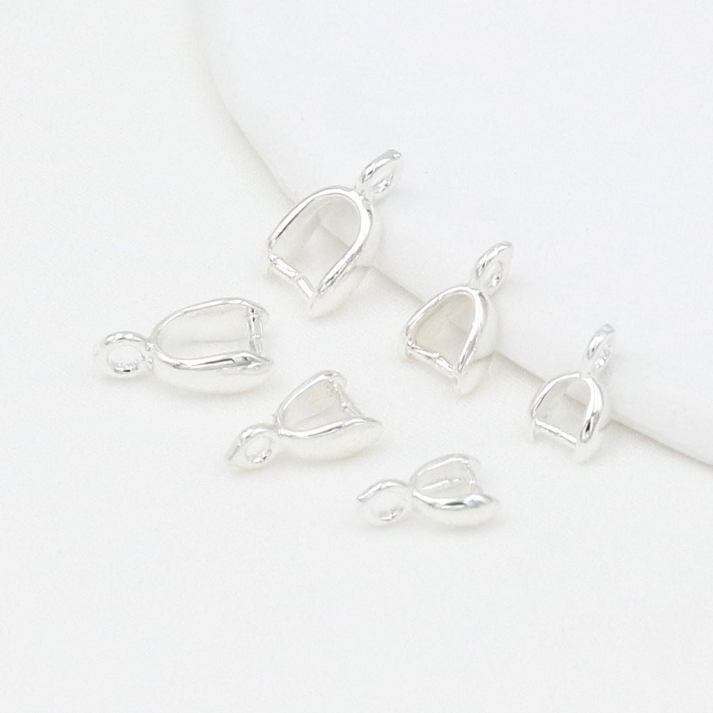 Silver pinch bail pendant clasps with leaf-shaped cups on a white background