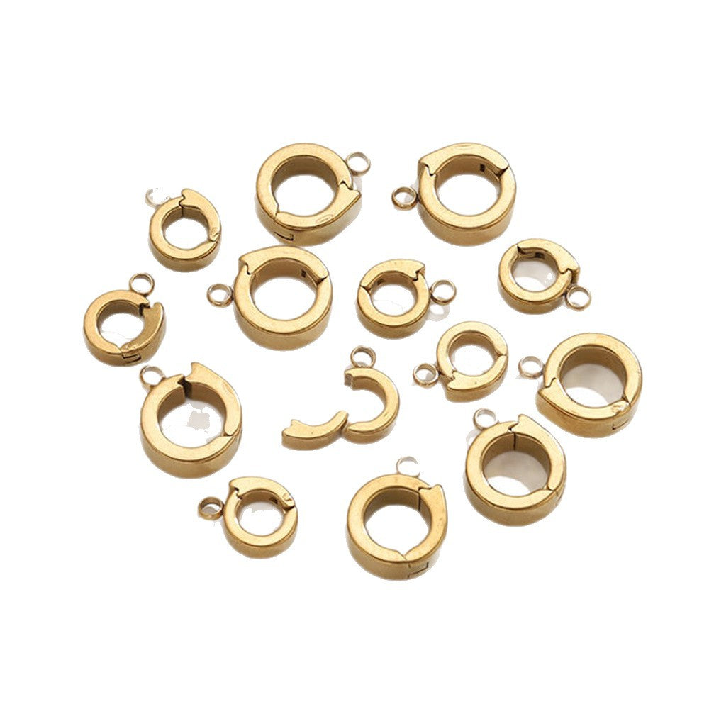 Gold open-ring connector clasps with attached loops arranged on white