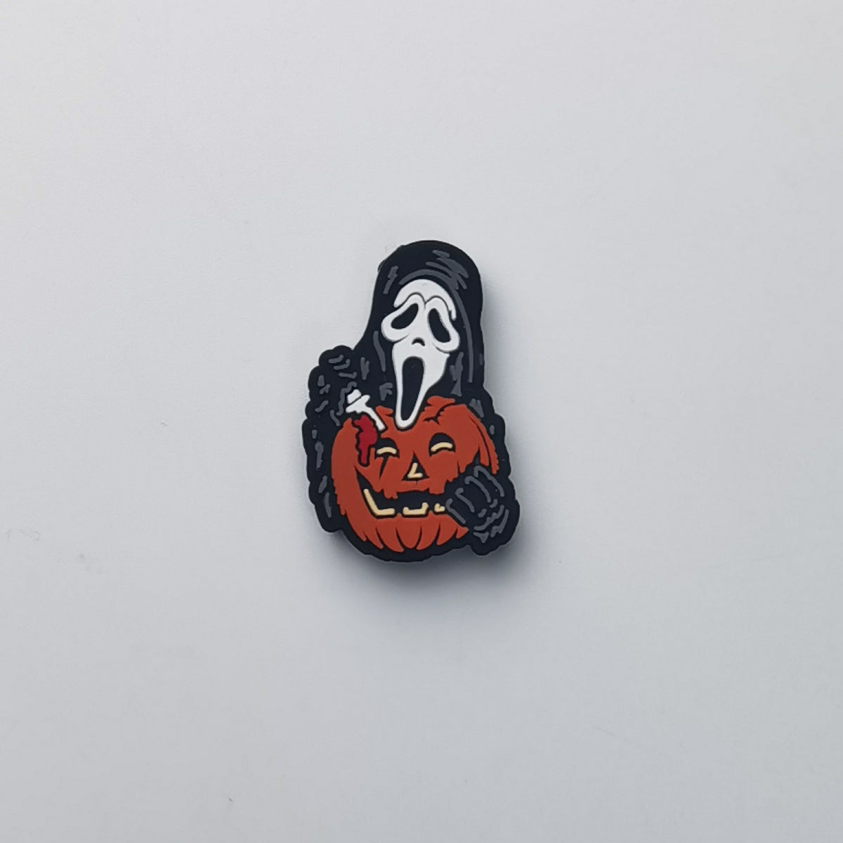 Ghostface bead with black hood holding orange pumpkin