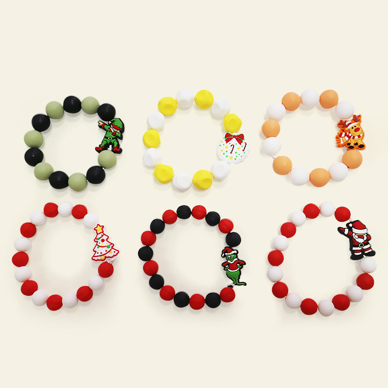 Six silicone bead bracelets with Christmas charms: elf, reindeer, tree, Santa, and monster charms on colorful beads.