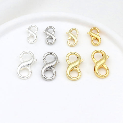 Eight figure-eight lobster clasps in two sizes and silver and gold finishes arranged in two rows on white