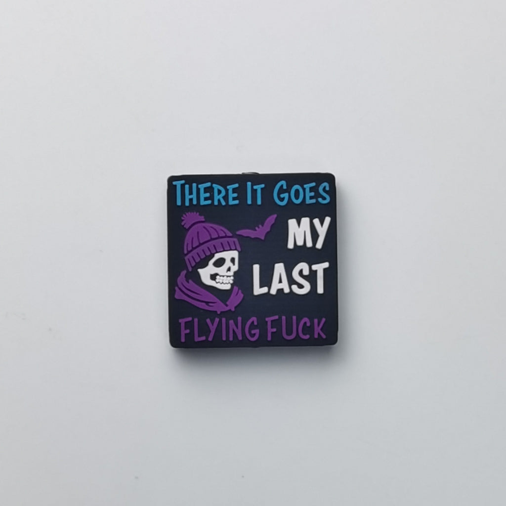 Square black bead with skull in purple beanie and There It Goes text