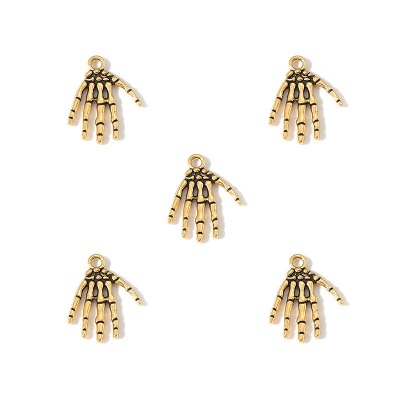 Five gold skeleton hand charms arranged on a plain white background.