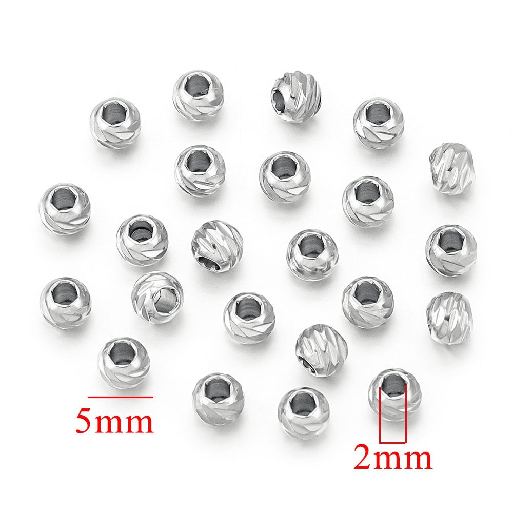 Silver steel-color diamond-cut stainless steel wheel spacer beads with size measurements on white background