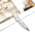 Rhinestone ballpoint pen with Santa Claus motifs.