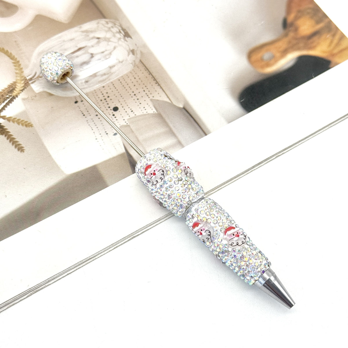 Rhinestone ballpoint pen with Santa Claus motifs.