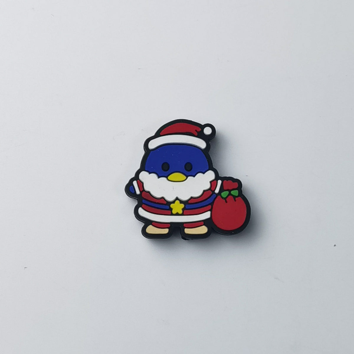 Blue penguin silicone focal bead dressed as Santa, with red hat, white beard, yellow star and red sack