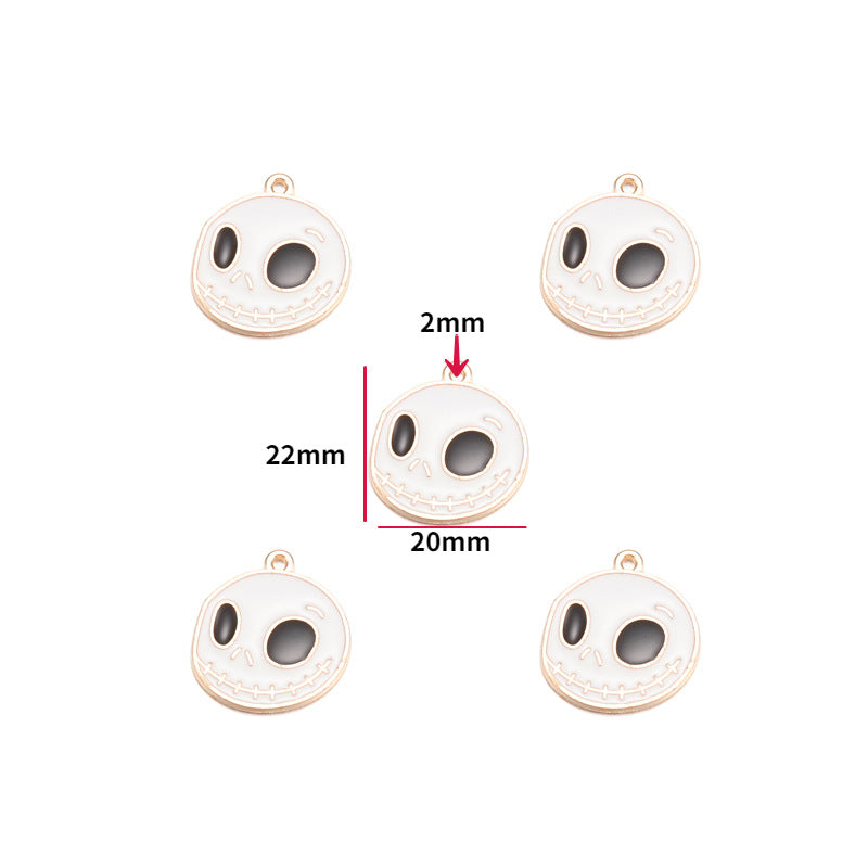 Five round skull-shaped jewelry charms with a white enamel face and gold-tone metal borders, 22mm by 20mm size shown