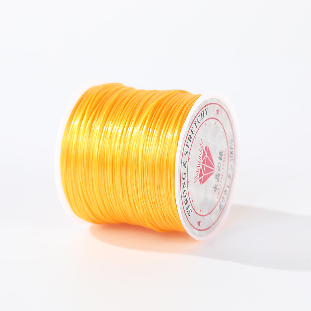 Spool of bright yellow 0.8mm flat elastic beading cord on its side, circular diamond label, white background