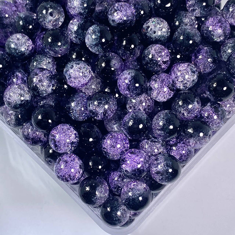 Close-up of purple and black glittery beads in a container