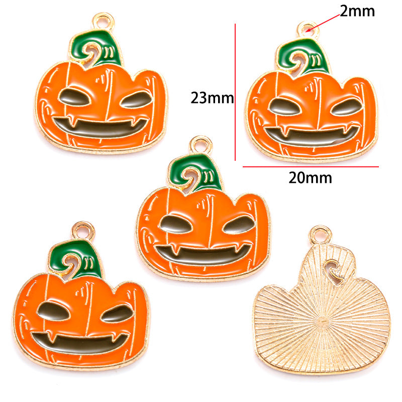 Five pumpkin-shaped charms with orange enamel, green tops and gold outlines, 23mm by 20mm
