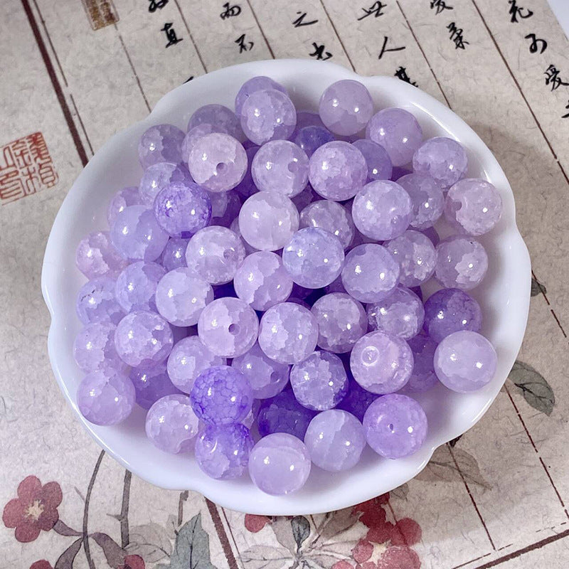 Lavender-purple 10mm water-dyed jade-style crackle glass beads in a white dish