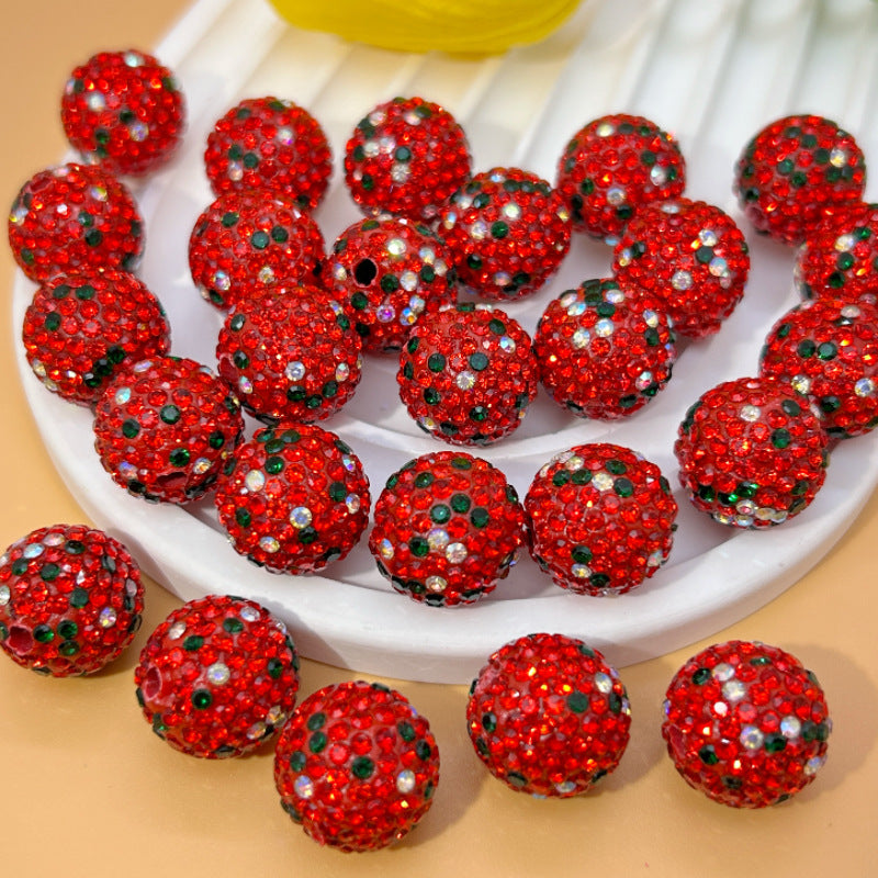 Red embellished Christmas beads on a white plate.