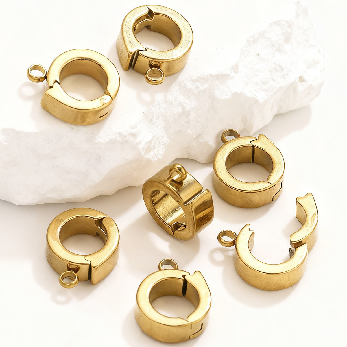 Close-up of gold stainless steel open-ring connector clasps
