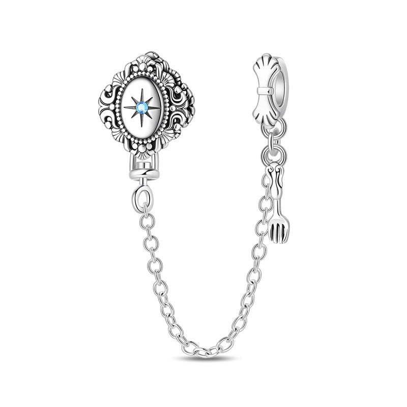 Silver-plated ornate oval medallion dangle charm with blue crystal star center and chain with fork pendant