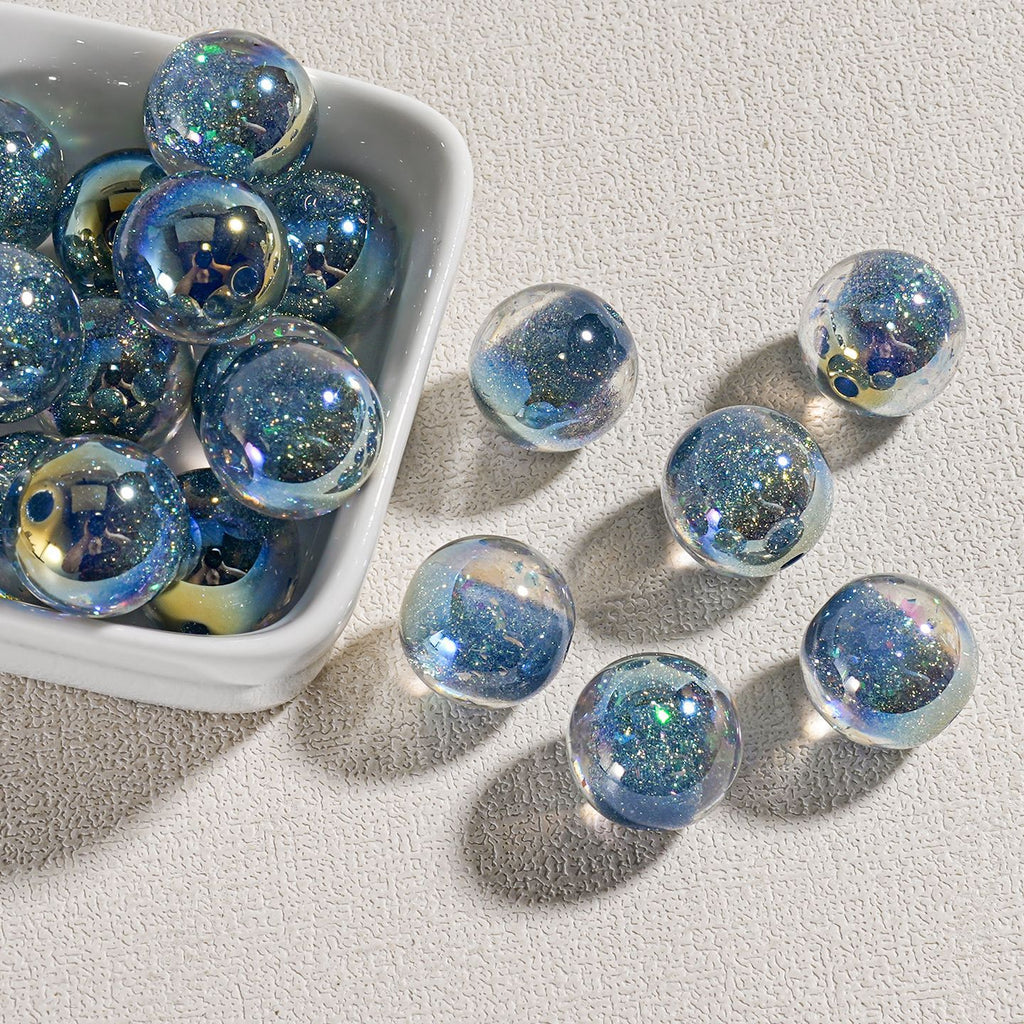 Iridescent blue candy-core opal-effect resin round beads with embedded glitter in small white dish