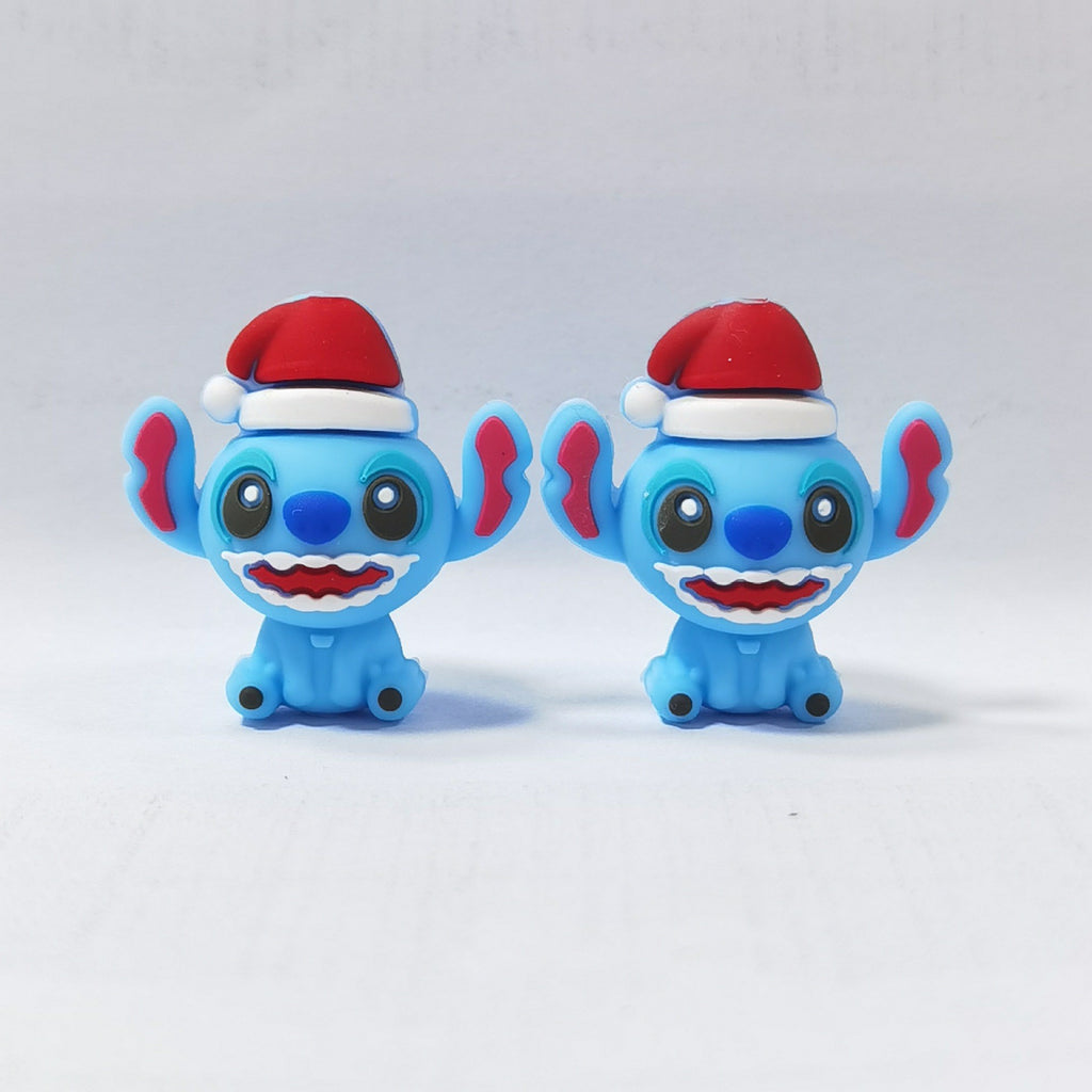 Two blue cartoon character silicone focal beads wearing red Santa hats