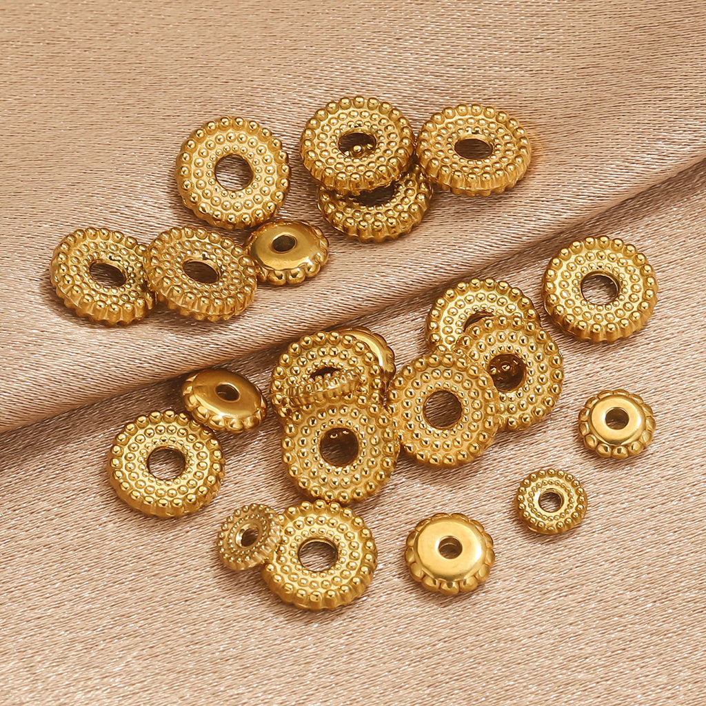 Group of small gold-plated dotted gear wheel stainless steel spacer beads with ridged edges