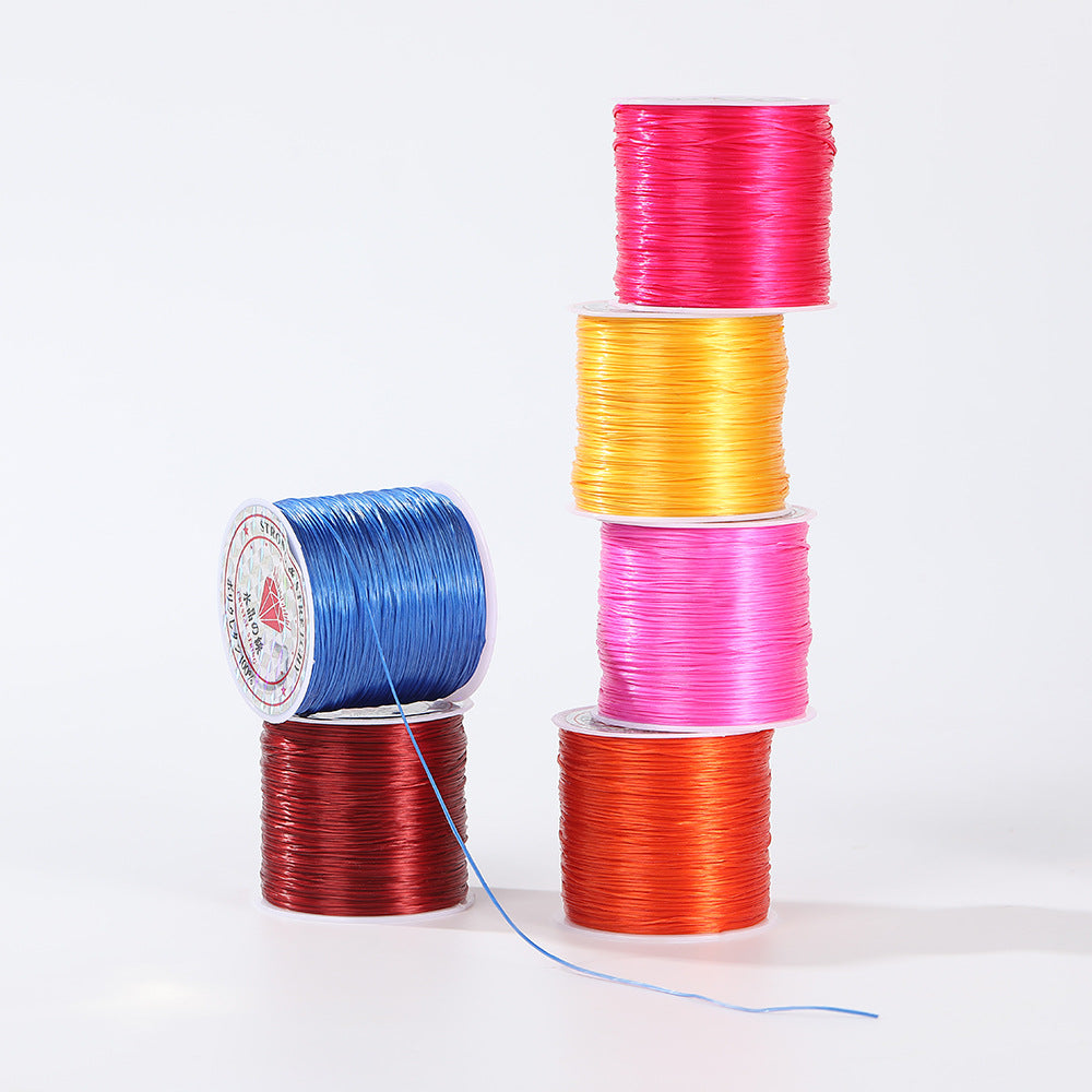 Six spools of shiny flat elastic beading cord in pink, yellow, magenta, orange, blue and dark red