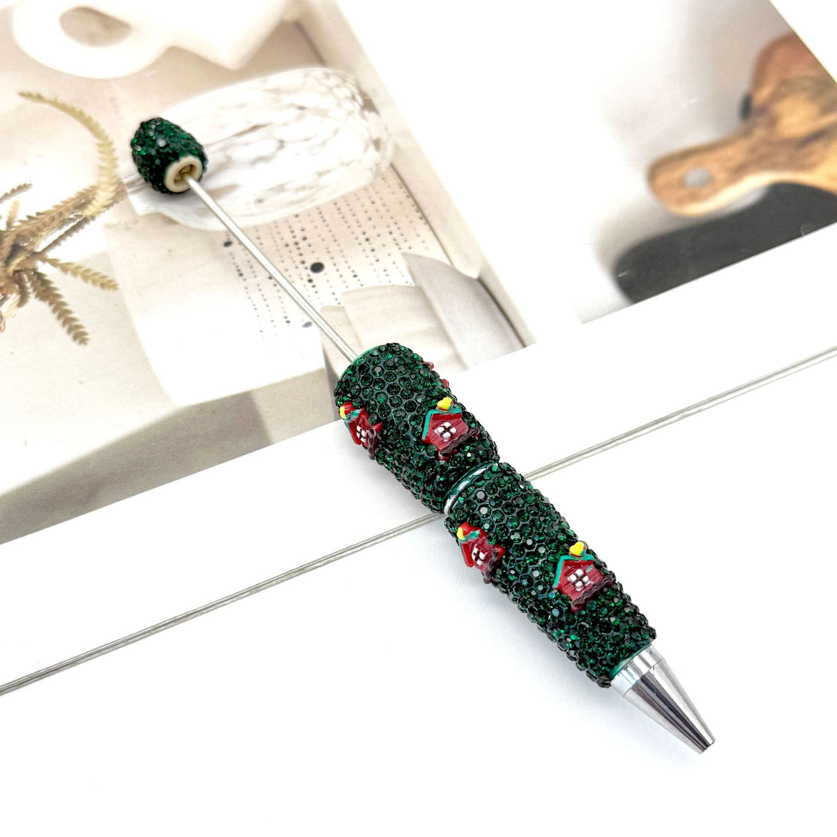 Dark green rhinestone ballpoint pen with silver metal tip.