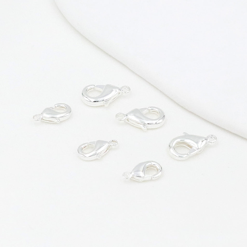 Silver teardrop lobster clasps on a white background