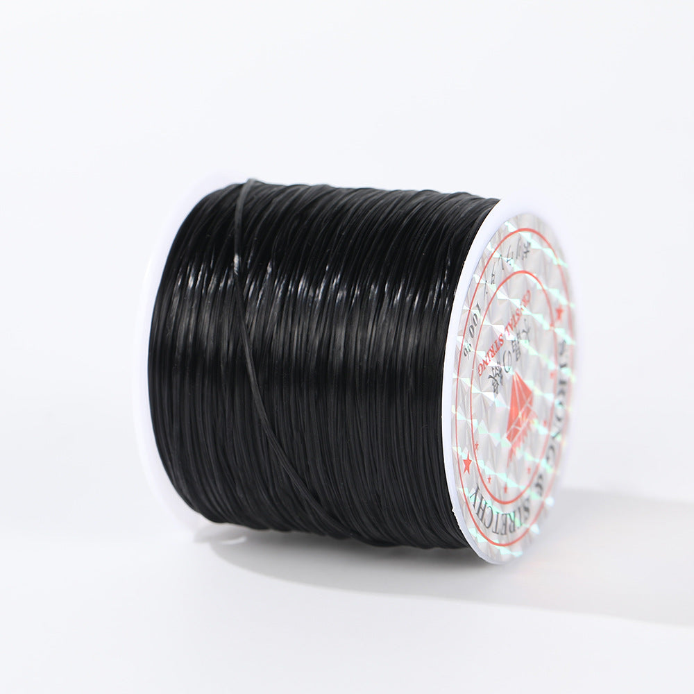 Spool of black 0.8mm flat elastic beading cord lying on its side, printed label facing viewer, white background