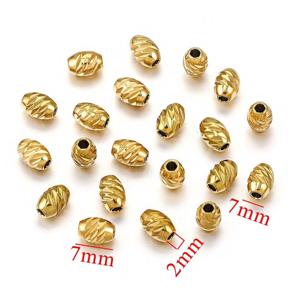 Gold-plated diamond-cut stainless steel wheel spacer beads with size measurements on white background