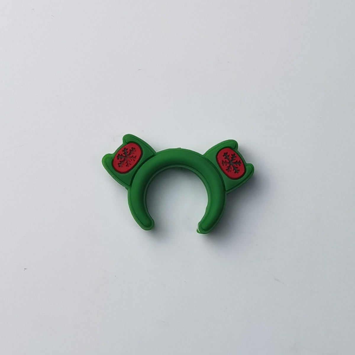 Green frog-themed silicone ring with red circular eye patches and black details, on a plain background