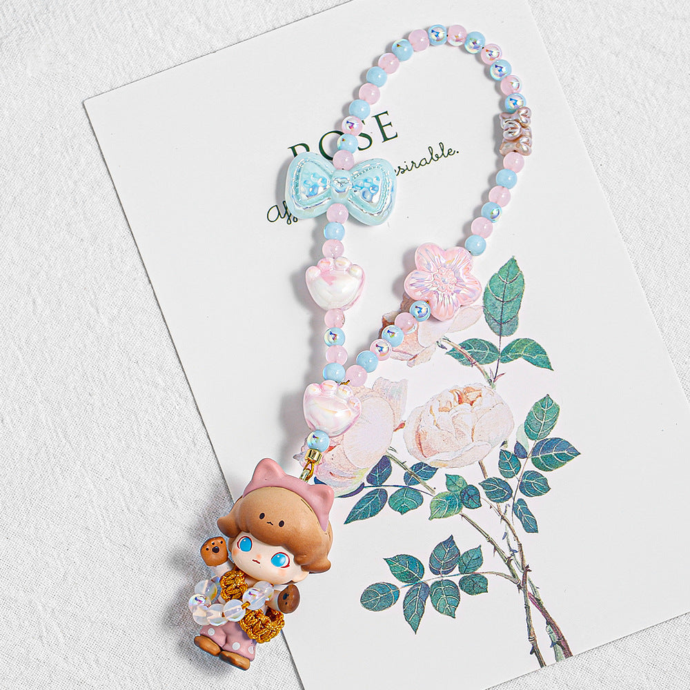 Beaded phone strap with pink and blue beads, bow charms and cartoon doll pendant