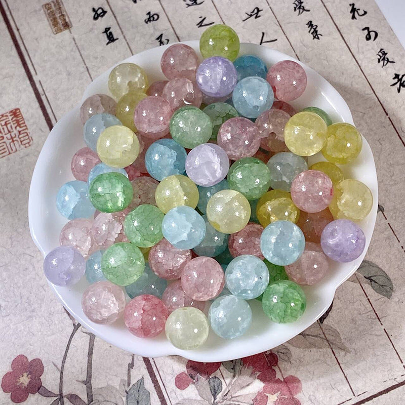 Assorted pastel multicolor 10mm water-dyed jade-style crackle glass beads in a white bowl