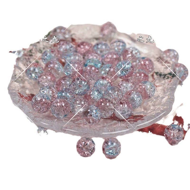 Pastel pink, blue, and purple glittery beads on a clear glass dish
