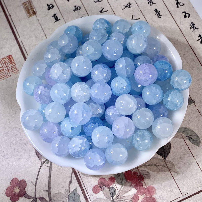 Light blue 10mm water-dyed jade-style crackle glass beads in a white bowl