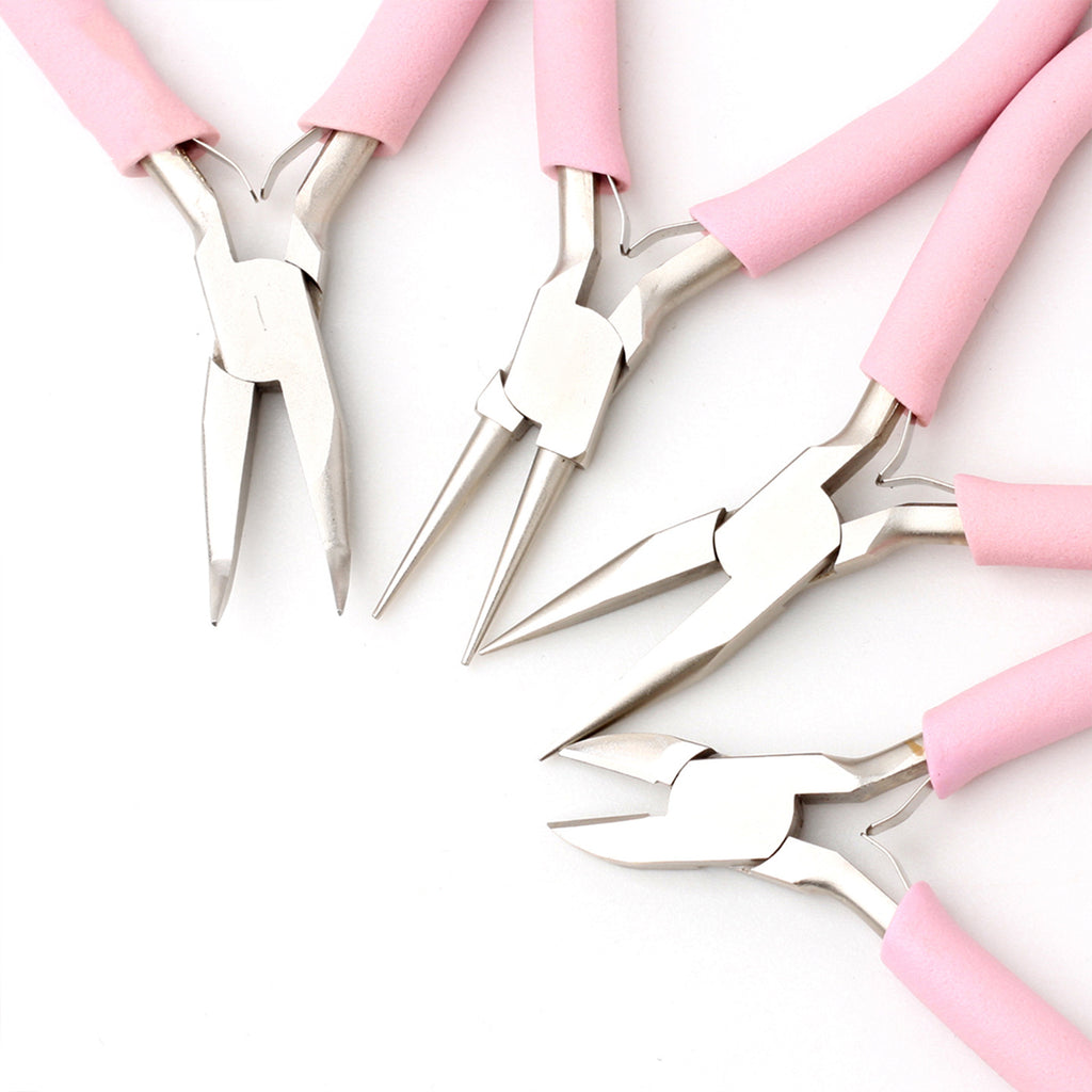 Four pink-handled precision pliers arranged diagonally on white