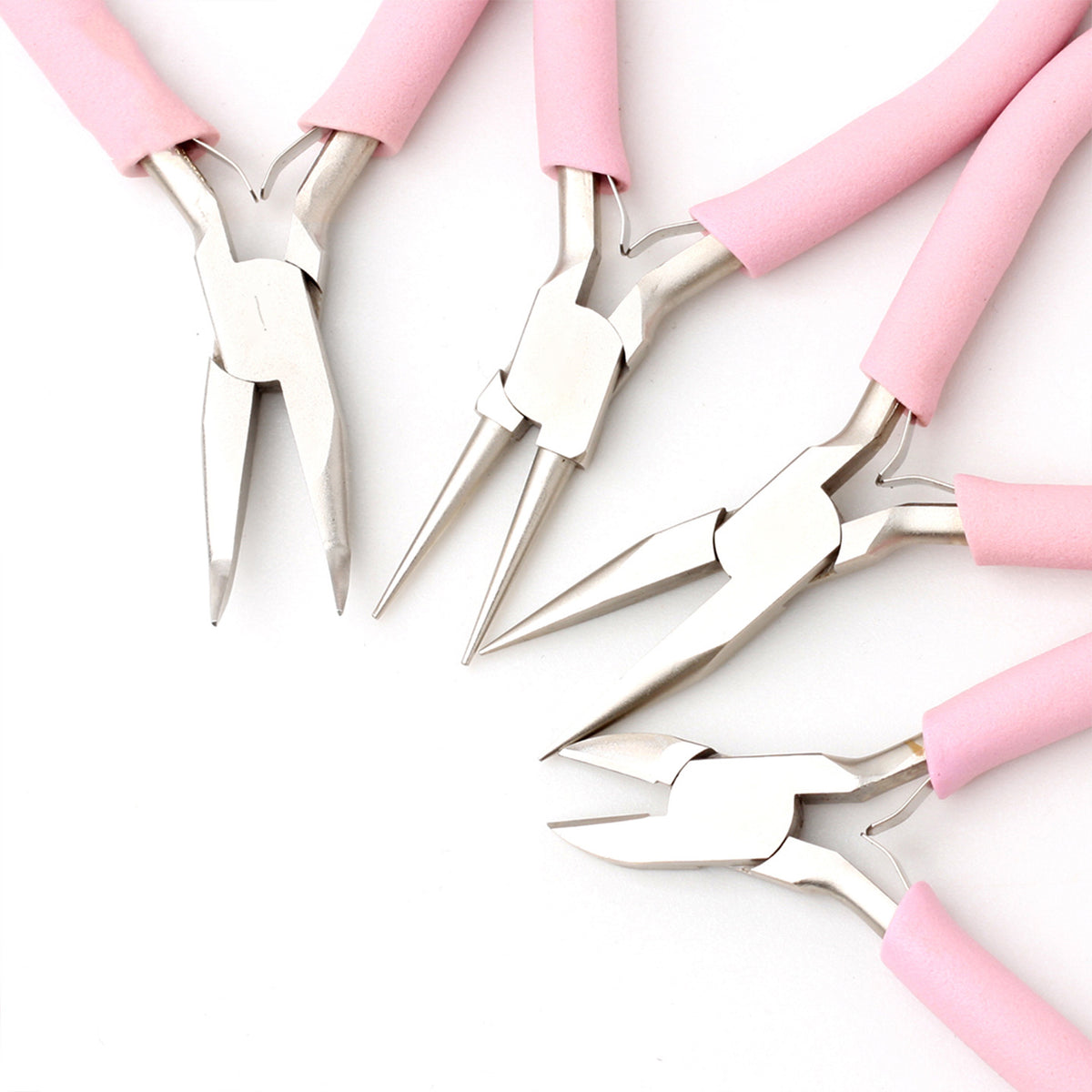 Four pink-handled precision pliers arranged diagonally on white