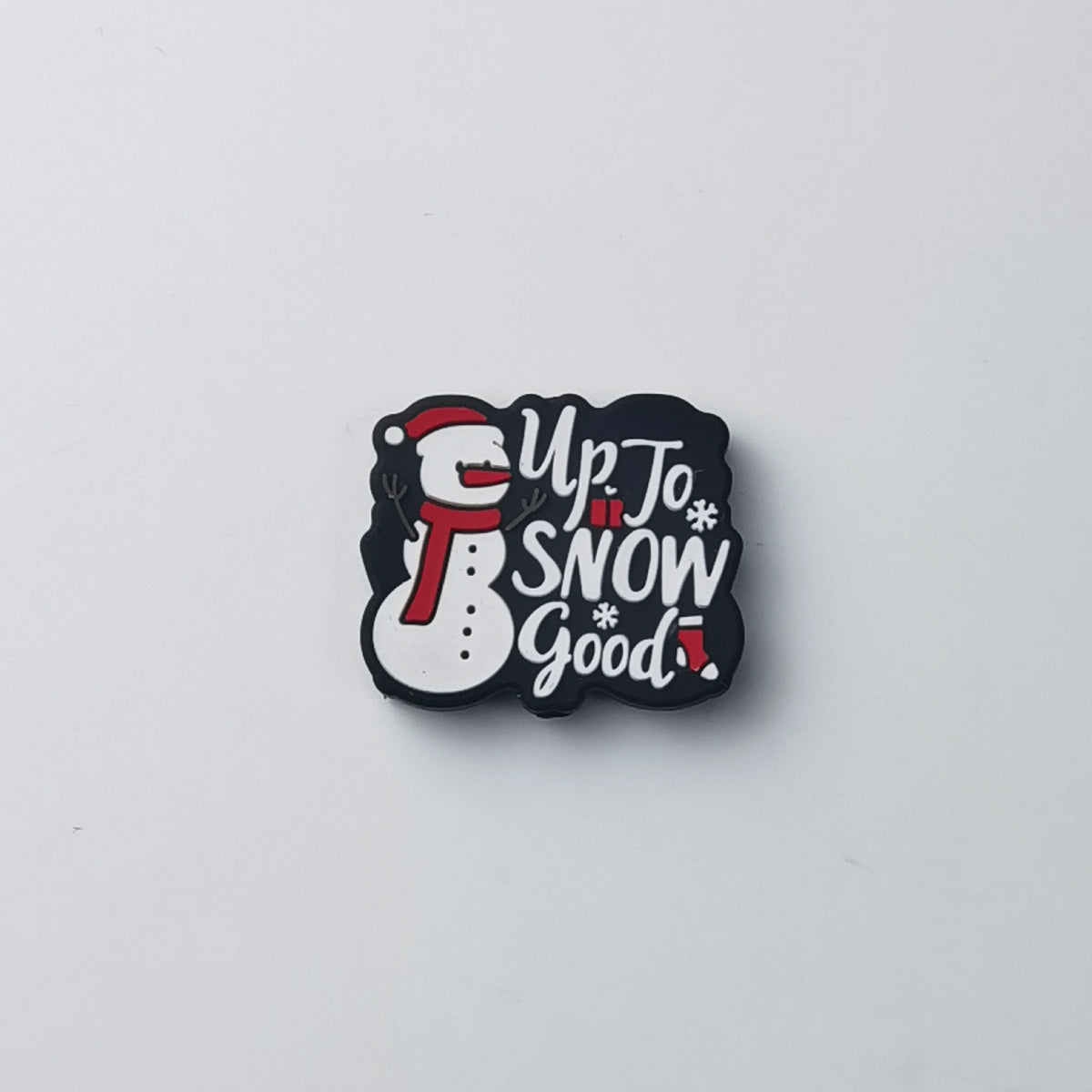 Black silicone focal bead shaped like a snowman with white 'Up to Snow Good!' lettering