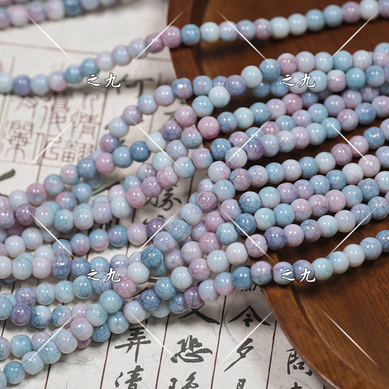 Multiple strands of pastel round porcelain beads in light blue, lavender, pink, white