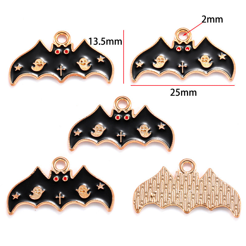 Five bat-shaped charms with black enamel, ghost motifs and red eyes, 13.5mm by 25mm
