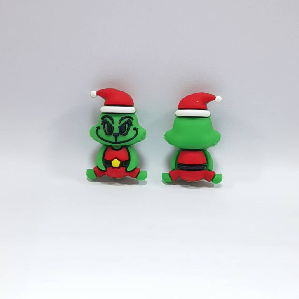 Two green Grinch-like silicone focal beads in Santa hats and red outfits, front and back