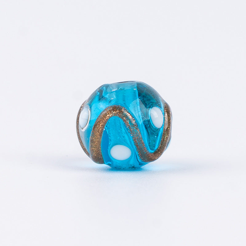 Single blue gold-sand swirl glass bead with white polka dots and gold swirls